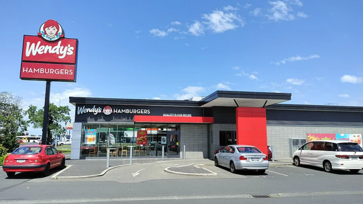 wendy’s restaurant exterior with sign and parking lot