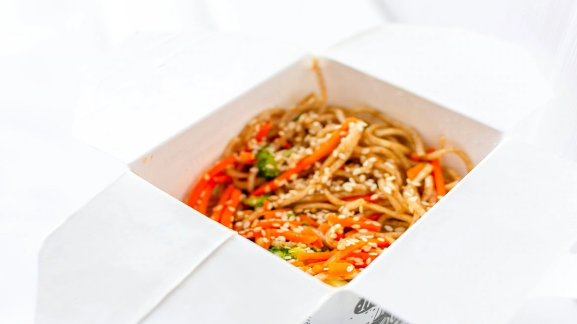 sesame noodles in white takeout box