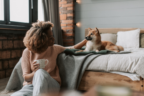 woman and shiba inu in cozy bedroom