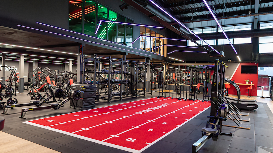 modern gym interior with red turf track